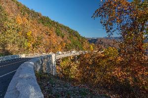 Photo of the Foothills Parkway in Great Smoky Mountains National Park with a scenic view of mountains and fall colors.