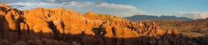 Fiery Furnace area of Arches National Park as viewed from above. Photo shows red rock spires, a broad valley below an anticline, and the La Sal Mountains in the distance.