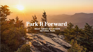 "Park It Forward" text is visible over an image of a sunrise over many peaks and vegetation in Great Smoky Mountains National Park.