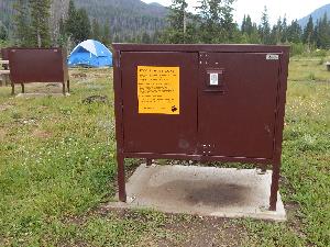Photo of a brown food storage locker in a campground at Rocky Mountain National Park.