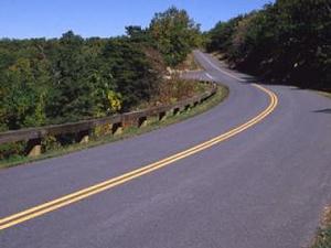 image of the current guardrail on a curve at mile marker 229 of the Parkway