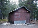 Photo of the Le Conte Ranger Station showing the front of the building and past repair work.