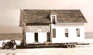 Photograph of the U.S. Life-Saving Station on a trailor during its relocation in 1955.