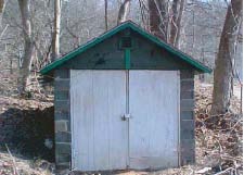 Color photo of the cement block shed.