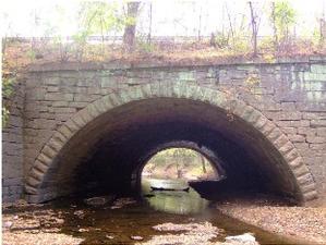 Photograph of Culvert 182 at Hancock, MD.  This stone masonry culvert is the largest historic culvert structure in the park.  The Little Tonoloway Creek flows through the culvert.