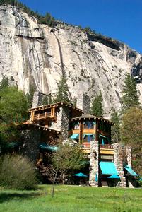 Photo of the exterior of The Ahwahnee National Historic Landmark and granite cliffs in the background in Yosemite National Park. Photo credit - Chris Falkenstein