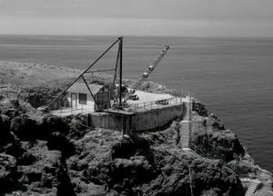 Black and white aerial photo of the historic derrick crane on the upper landing of Anacapa Island.