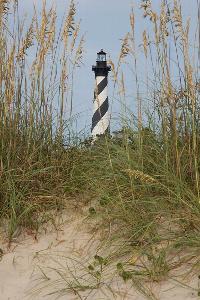 Cape Hatteras Lighthouse behind dunes with sea oats