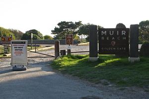 Photo at entrance to Muir Beach parking lot with gate closed and sign reading "Area Closed - Do Not Enter - Hazardous Contaminants in Water"