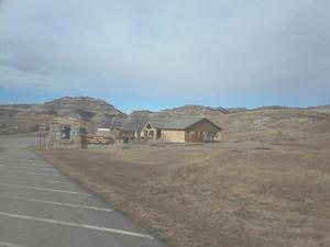 Photo of the Abandoned Visitor Center with the Badlands terrain in the background. 