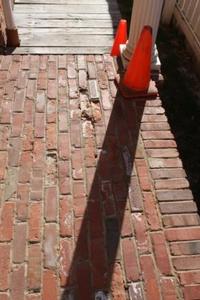 Photo of brick sidewalk with small sinkhole on south side of Education/Conference Center