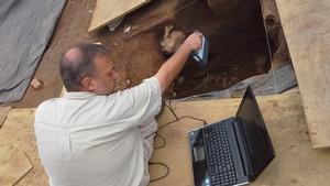 Three-dimensional scanning of an archeological feature at Ferry Farm, 2014.