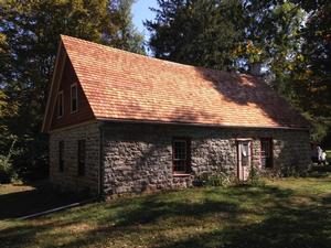 Photo of the Westbrook-Bell House, built in the early 1700s.  The house is built of stone, is a story-and-a-half tall, and has a wood shingle roof.