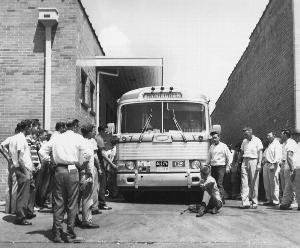 Photo of one unidentified white man sits in front of Grayhound bus to prevent it from leaving the station with load of Freedom Riders, AP Photo.