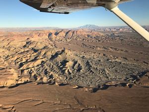 Photo of landscape taken from an airplane within Glen Canyon National Recreation Area with Navajo Mountain in the background.