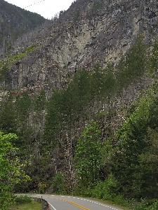 Looking up at the Spacewall rock formation with Washington State Route 20 in the foreground.