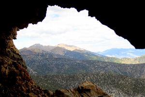 View of Wheeler Peak from Wild Goose Cave, with cave entrance framing the high peaks.