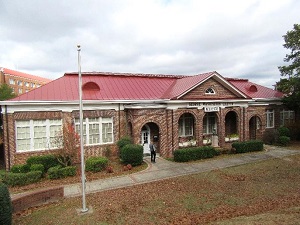Photo of the brick George Washington Carver Museum with red roof and grass landscaping