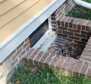 Photo of window well pulling away from foundation