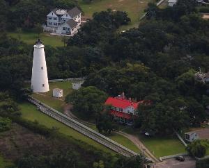 Aerail view of the Ocracoke Light Station Site showing the lighthouse, oil house, generator house, double keepers quarters, parking area and boardwalk.