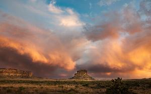 Photo of Fajada Butte with a very colorful sky in the back ground.